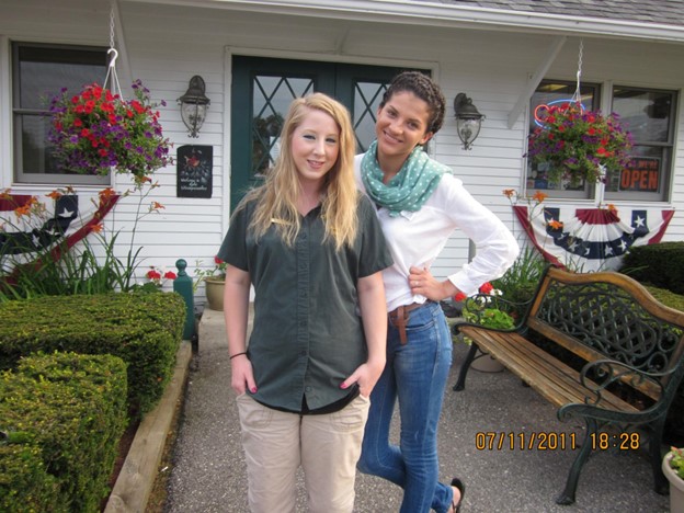 Lucia poses for a picture with a coworker outside of her Work and Travel assignment in New Hampshire.