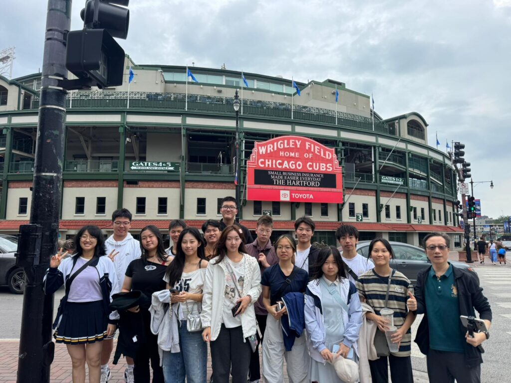 Chinese exchange students pose for a photo in front of Wrigley Field, home of professional baseball team, the Chicago Cubs.