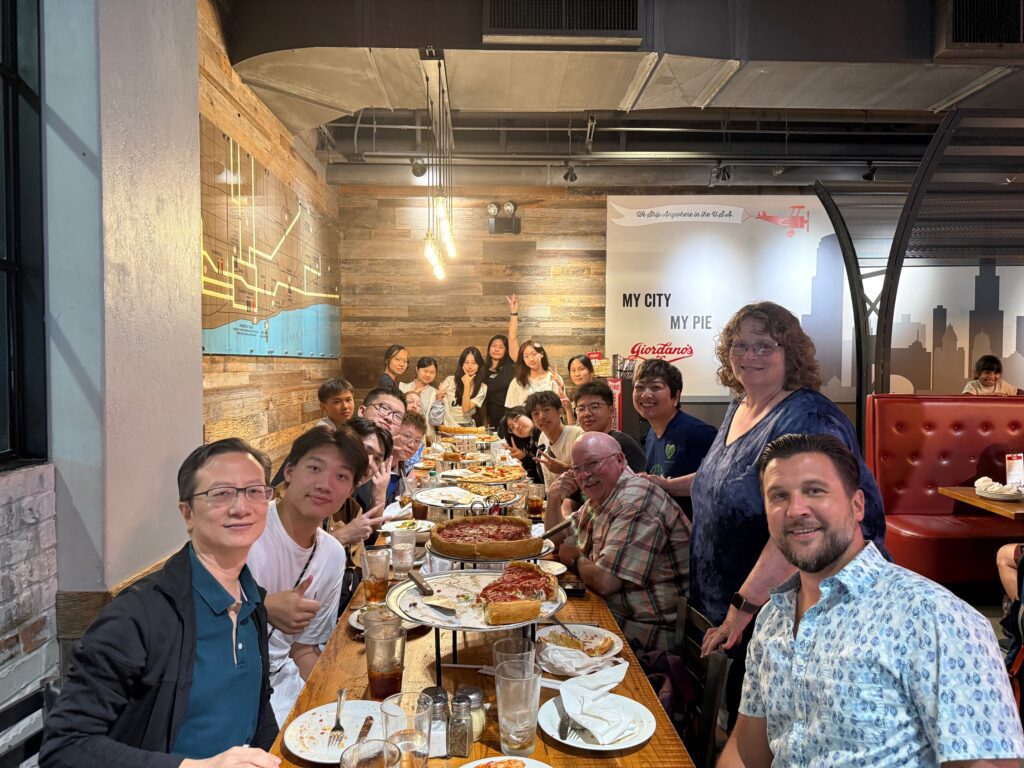 The Chinese exchange students pose for a picture at Giordano's Pizza, along with local coordinator, Tammy Zilinski, VP of Marketing & External Relations, Marcelle Benedicta, and VP of International Business Development & Operations, Jason Nusser.