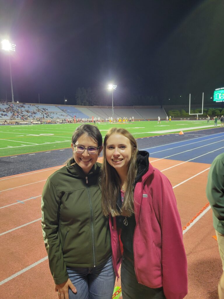 Meghan and Blanka pose for a photo at a high school football game- Blanka's first as an exchange student.
