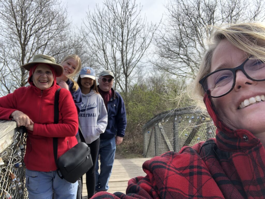 The Morse family, along with Ellen and Basia, pose for a picture on a bridge.